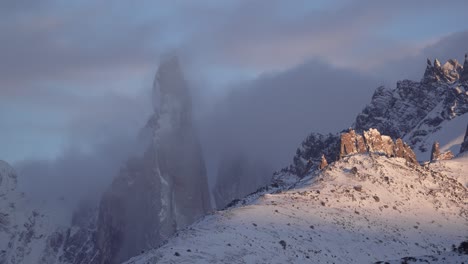 cerro torre snow-covered peak with clouds swirling in a timelapse at dawn in patagonia