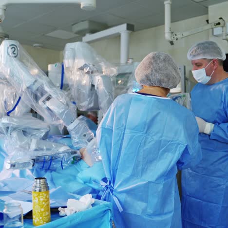 group of surgeons near the robotic machine. medical operation involving robot in the operating room. modern technologies in medicine.