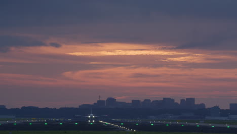 airplane landing/takeoff at sunset over city