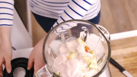 close up on a woman preparing a smoothie