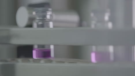 automated pharmaceutical production line with vials on conveyor belt in modern medicine manufacturing environment