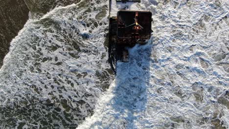 costa rica beach drone view showing sea, shore and a stranded ship