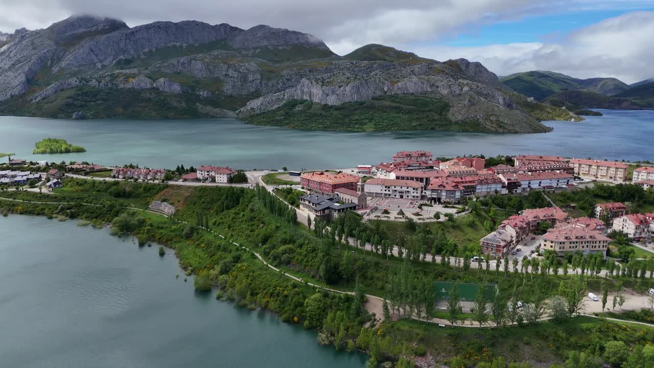 Aerial View of a Scenic Lakeside Town with Mountains