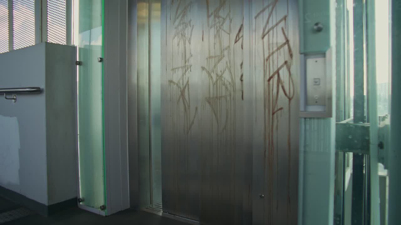 Woman with luggage waiting for elevator at a transit platform