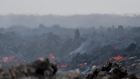 molten lava flow from grindavik volcano, sundhnúkur crater, iceland, with rising smoke and heat