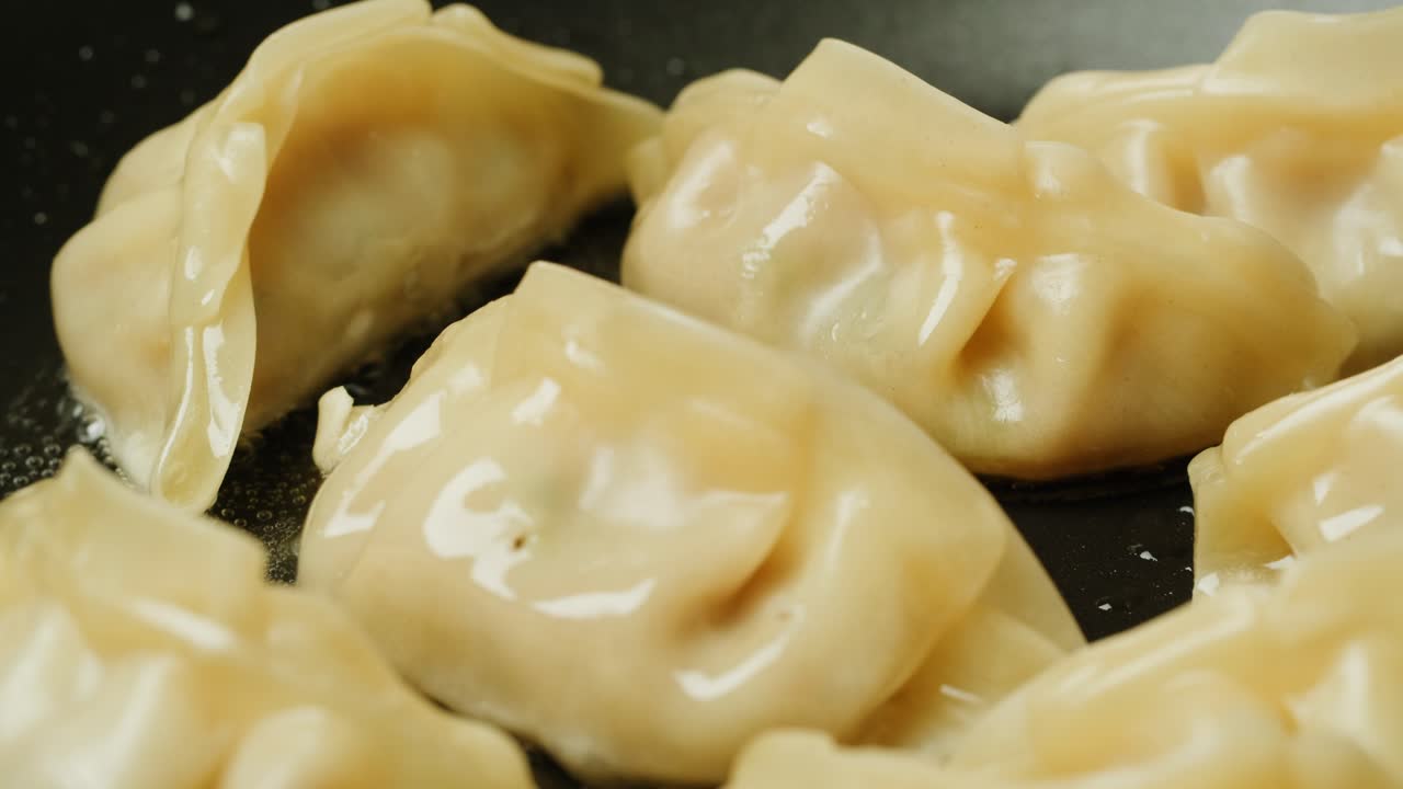 Close-Up of Delicious Dumplings Frying in a Hot Pan
