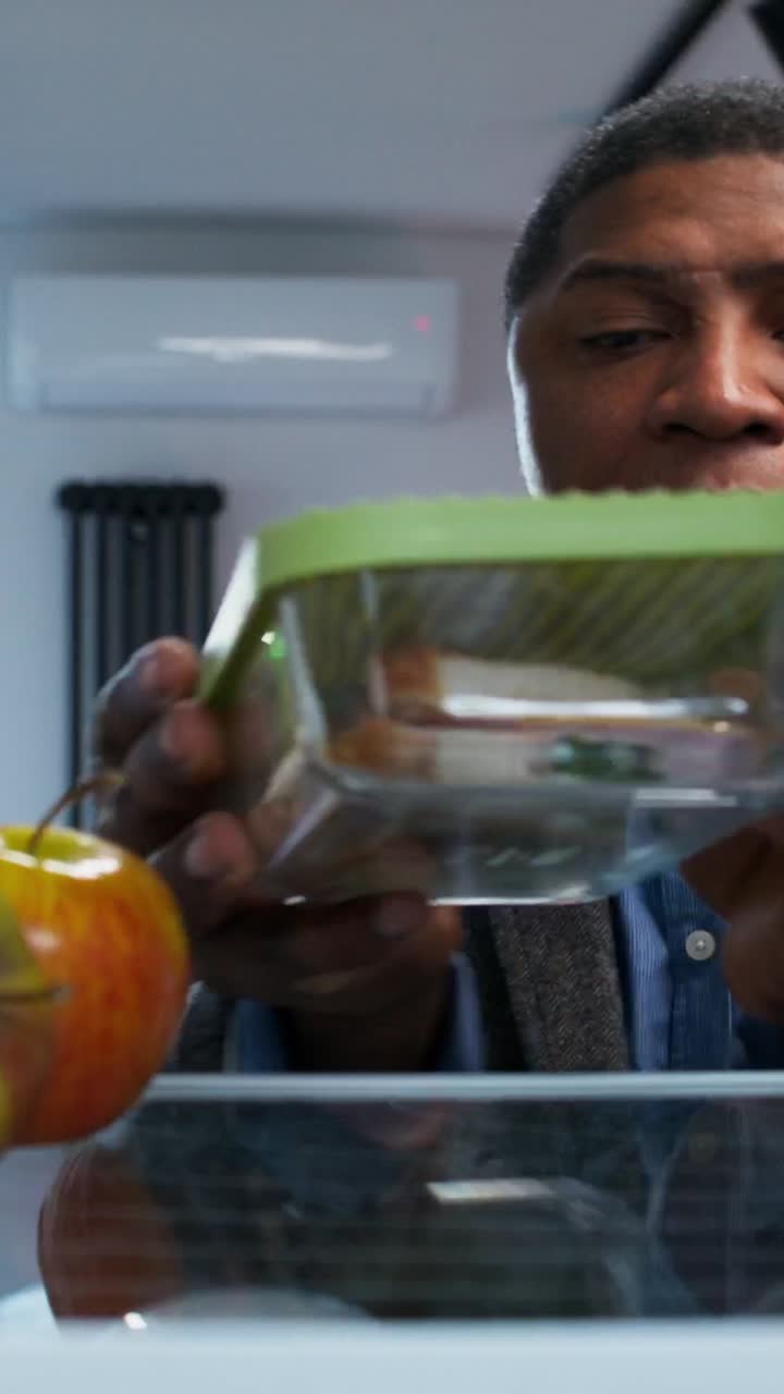 Person opening a refrigerator to get lunch