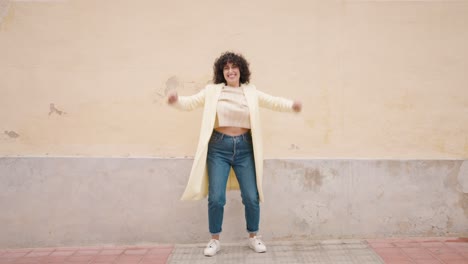 young woman smiling confident jumping at street