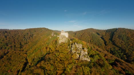 slow ascending fpv roundshot of aggstein in warm, autumn light, wachau, austria