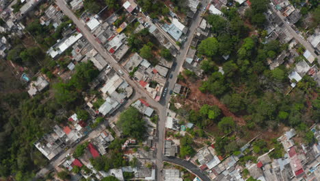 Aerial-birds-eye-overhead-top-down-descending-view-streets-in-suburbs.-Rotating-footage-of-houses-along-roads.-Valladolid,-Mexico