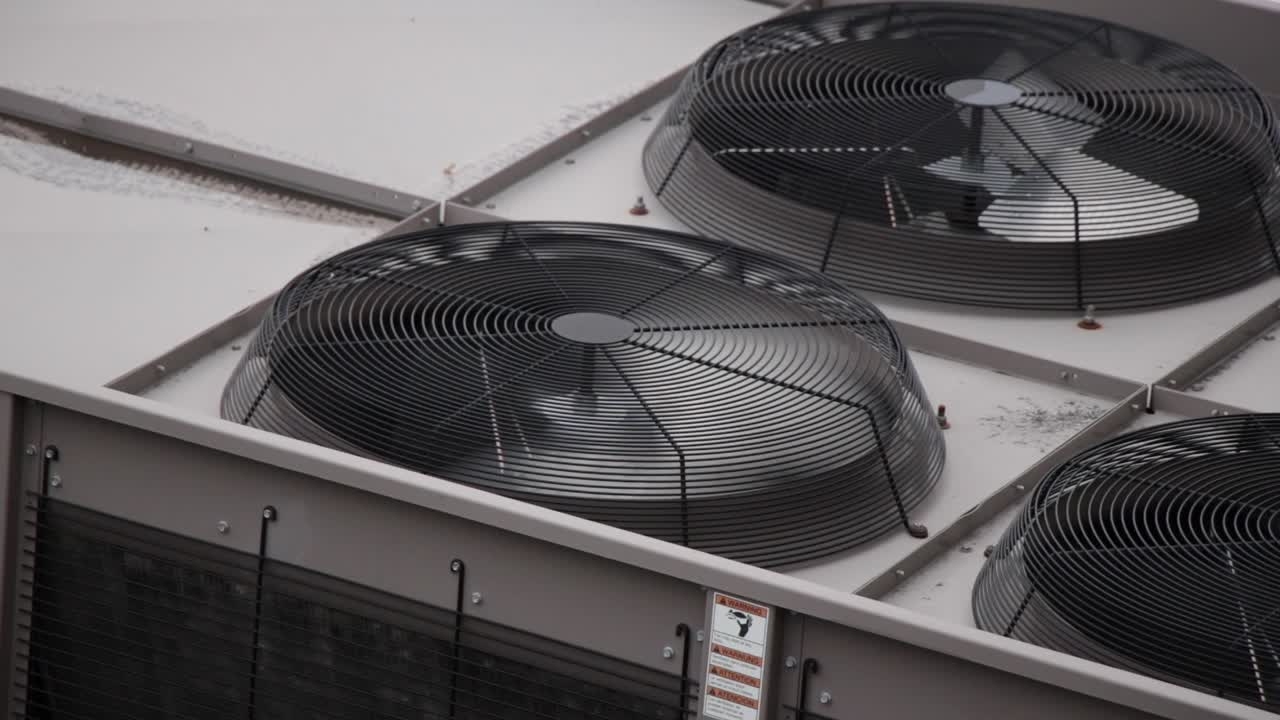Urban Fan with Rust spins in high speed as part of the HVAC air conditioning unit on top of city buildings