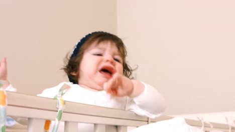 close-up of baby girl in baby cot