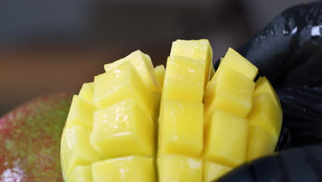 a halved and sliced mango is turned inside out