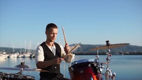 drummer playing drums at a harbor