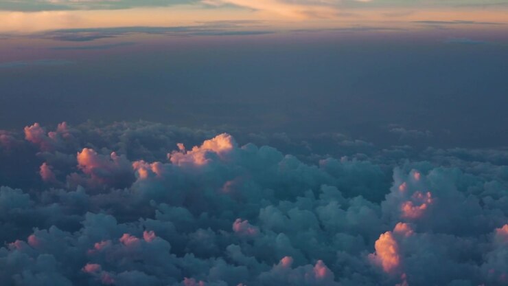 Flying over clouds at sunrise — Aerial.