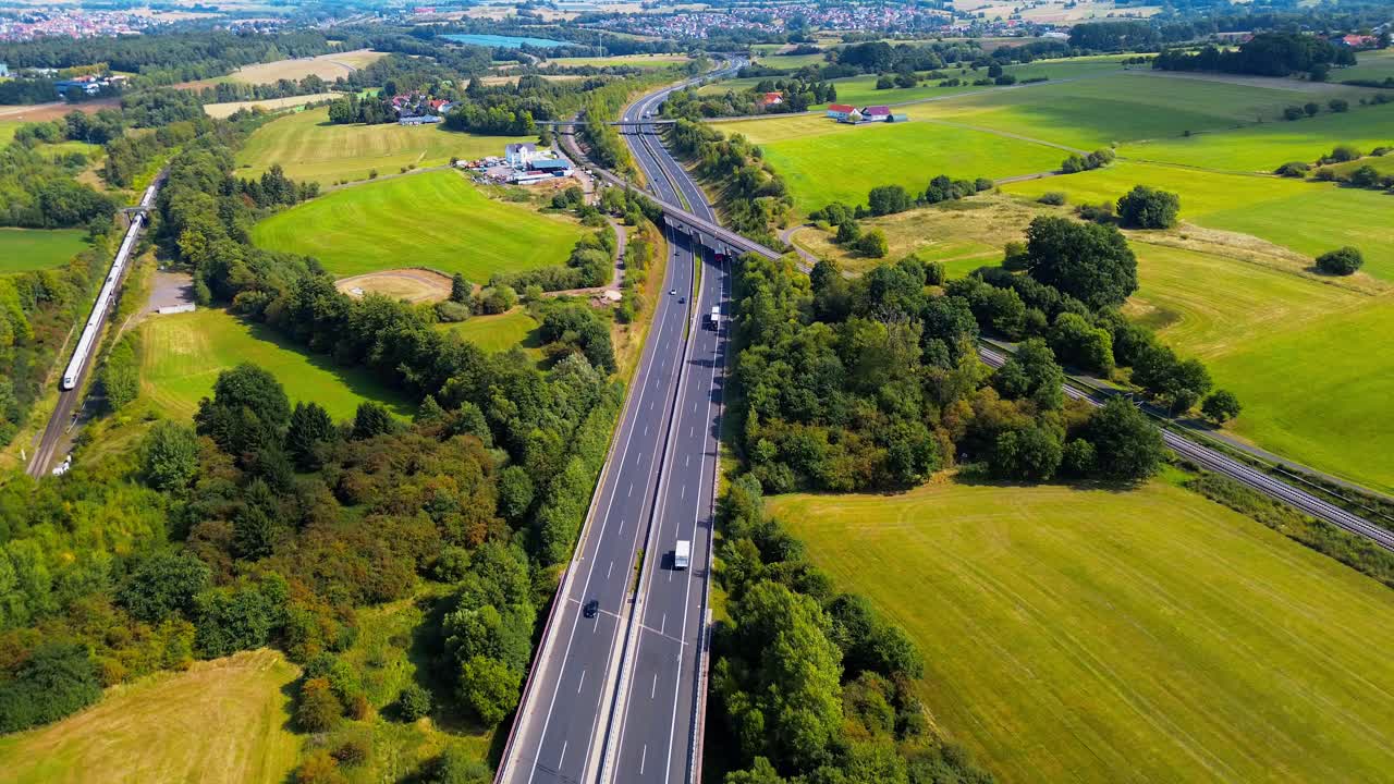 Highway and Railway Running Parallel Through Green Countryside