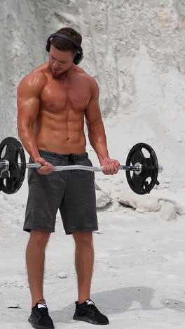 man exercising on nature. shirtless male model exercising outdoors vertical video