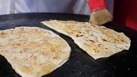 cooking gözleme on a hot plate
