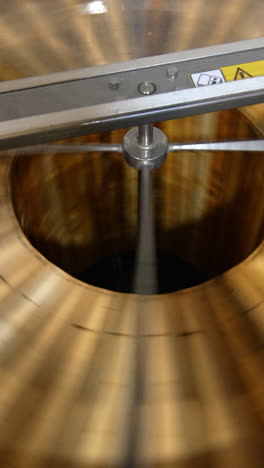 honey frames rotating inside the machine. electric equipment for pumping honey at apiary. view from top. vertical video