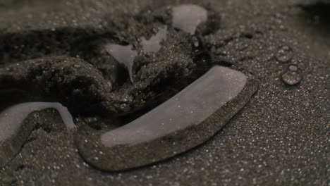 water on dark sand