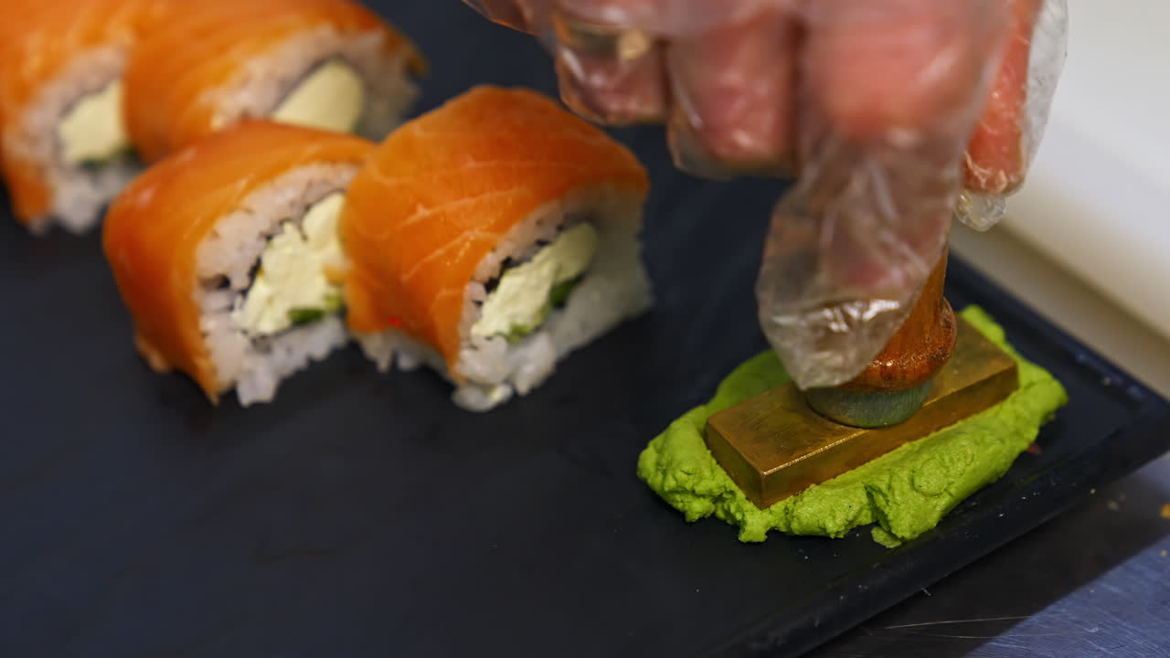 Sushi roll set on black slate background. Various sushi japanese food in restaurant. Set with salmon, tuna, vegetables, flying fish roe and caviar closeup. Japan restaurant menu.