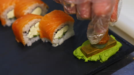 sushi roll set on black slate background. various sushi japanese food in restaurant. set with salmon, tuna, vegetables, flying fish roe and caviar closeup. japan restaurant menu.