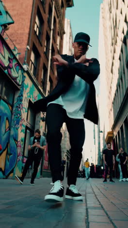 energetic street dance performance in a graffiti-adorned alley