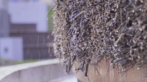 water dripping on thorny structure of graduation tower