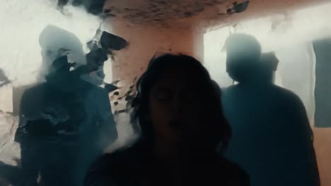 a woman in a shadowy room, scared and looking off screen.