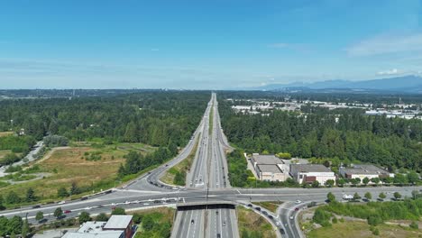 hyperlapse of cars driving in the highways on a sunny summer day in langley, bc, canada. - aerial shot