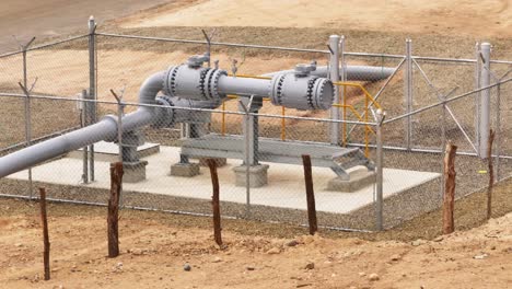 Aerial-orbiting-shot-of-gas-pipelines-at-thermoelectric-power-plant-on-scenic-field-in-Manzanillo,-Dominican-Republic