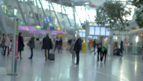 passengers walking around big and light airport hall