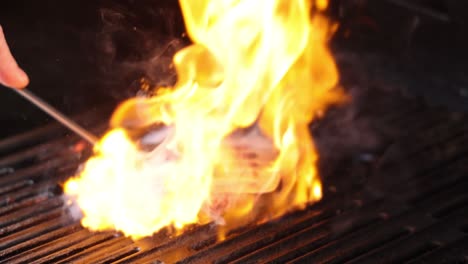 grilling burger patty with intense flames