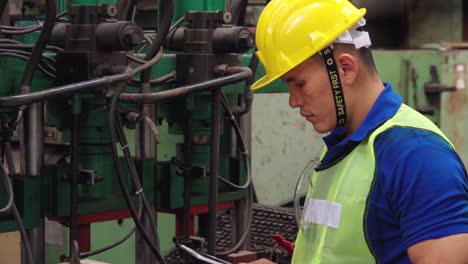 smart factory worker using machine in factory workshop