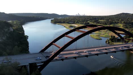 aerial drone shot overlooking pennyback bridge in austin, texas, usa of lake austin on a sunny morning