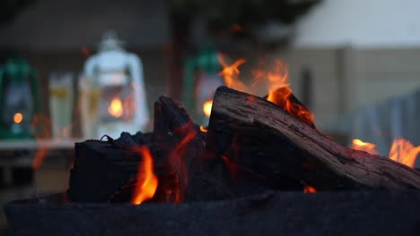 meat being flame grilled and cooked on an outdoor barbecue in an evening setting