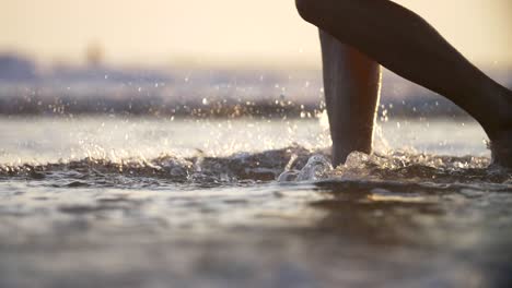 walking through surf and kicking up spray