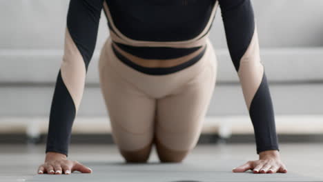 woman doing push-ups at home