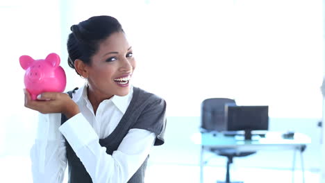 Businesswoman-checking-piggy-bank