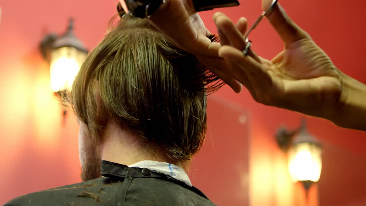 Man getting his hair cut by hairdresser 4k