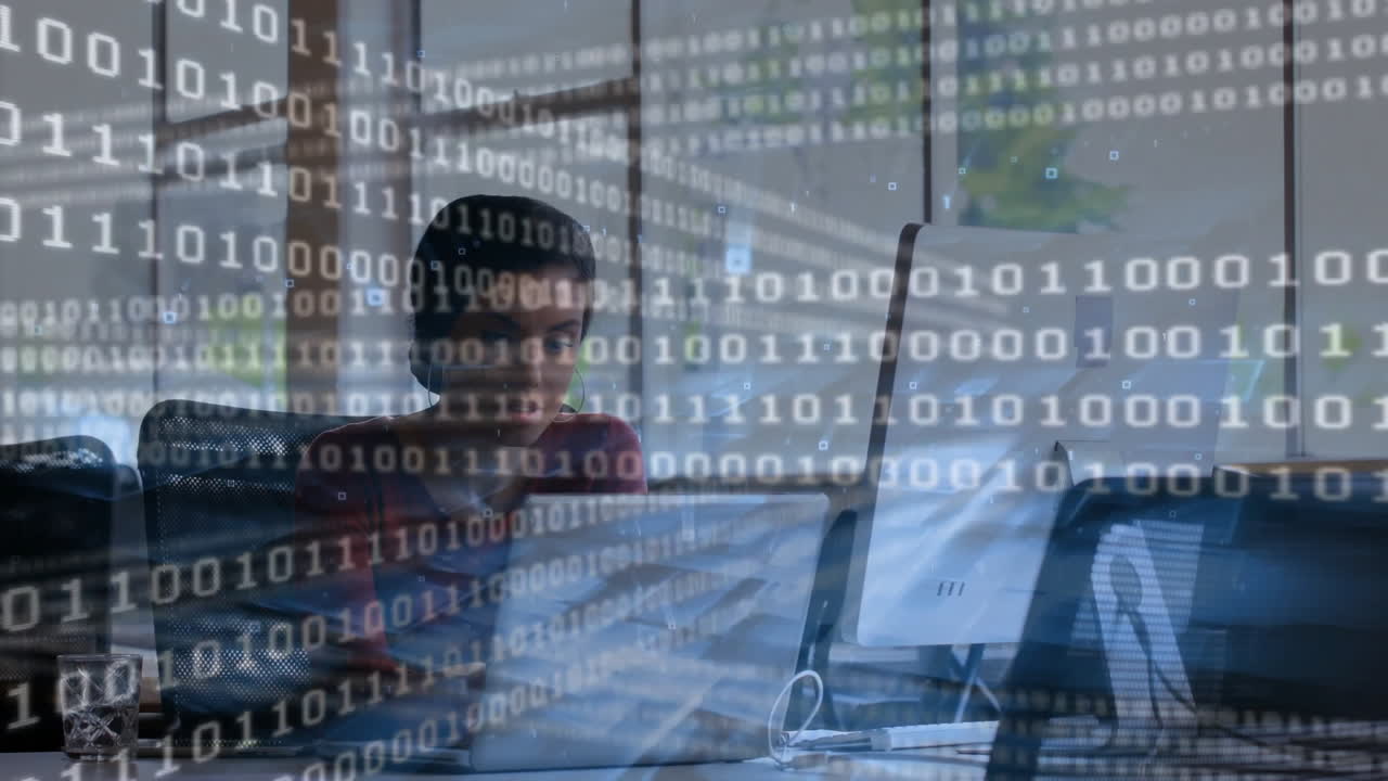 woman working on laptop in office, projecting binary code overlay showing cybersecurity concept
