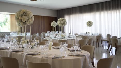 elegant wedding reception with white floral centerpieces, round tables, and soft lighting