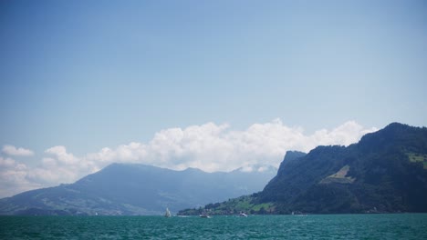 Peaceful-Panorama-View-of-Many-Sailboats-in-Distance-on-Mountain-Lake---Hergiswil-Switzerland-Mountains-in-4K