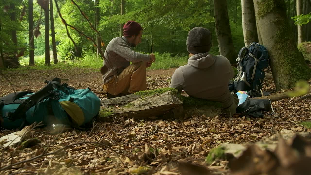 A couple enjoys an intimate conversation while taking a break from a romantic hike. This footage is perfect for themes of love, relationships, and shared experiences