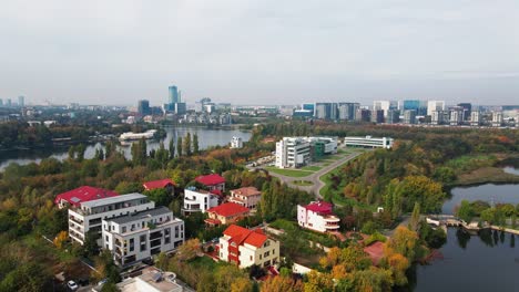 residential area with modern skyline north of bucharest, autumn colors, cloudy day, serene, aerial view