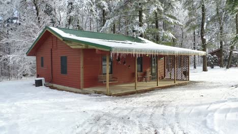 American-Traditional-Cabin-with-Porch-in-Snowy-Winter-Landscape,-Dolly-Reveal