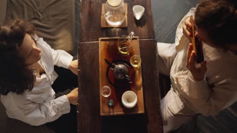 couple enjoying a traditional chinese tea ceremony