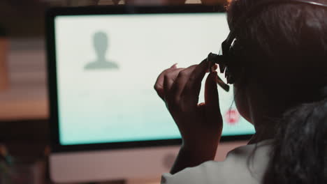 woman in headset on online call at night