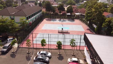 aerial view of badminton courts with surrounded green trees