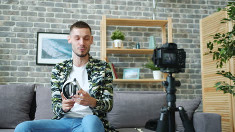 man reviews headphones on camera